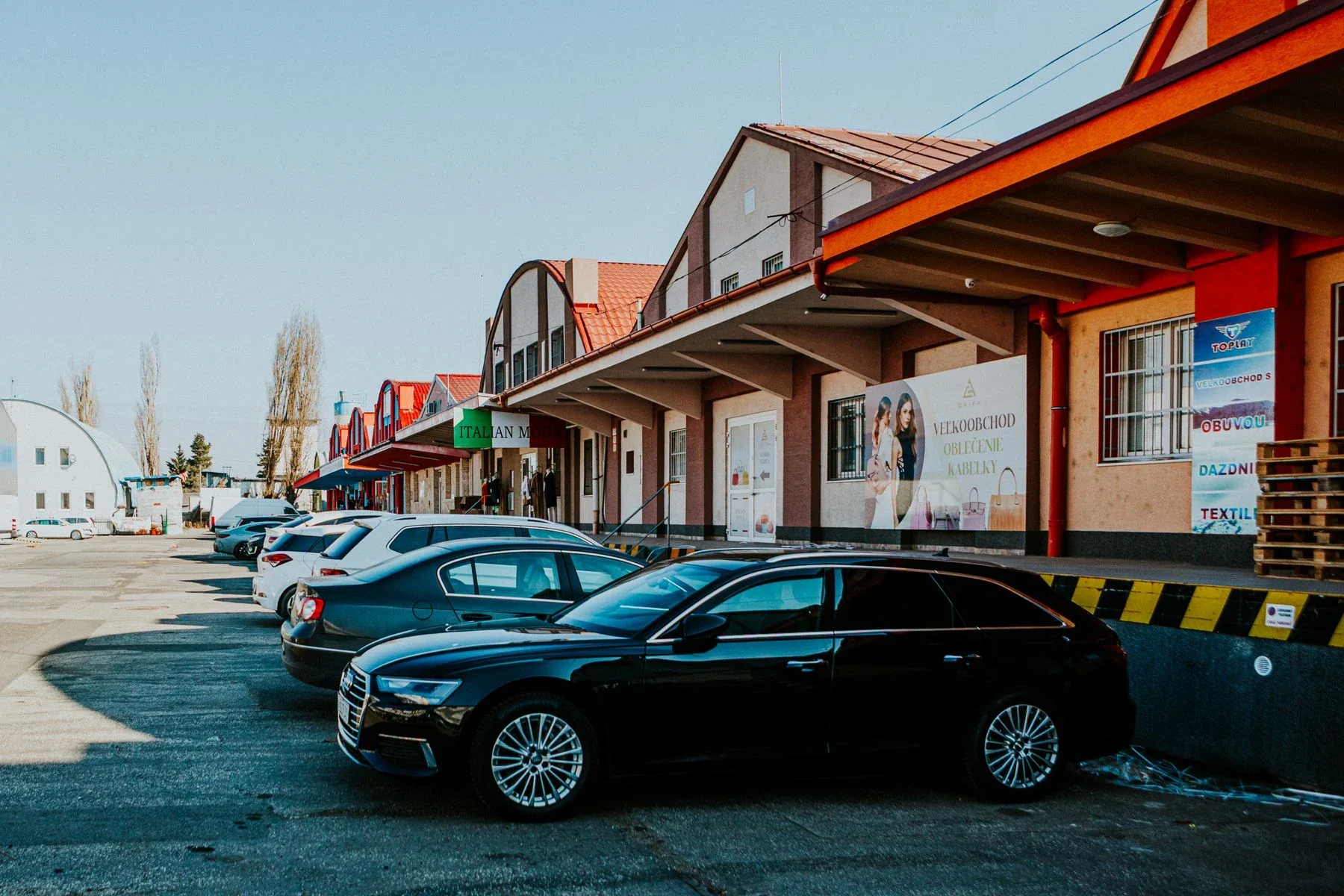 Several cars parked outside commercial premises