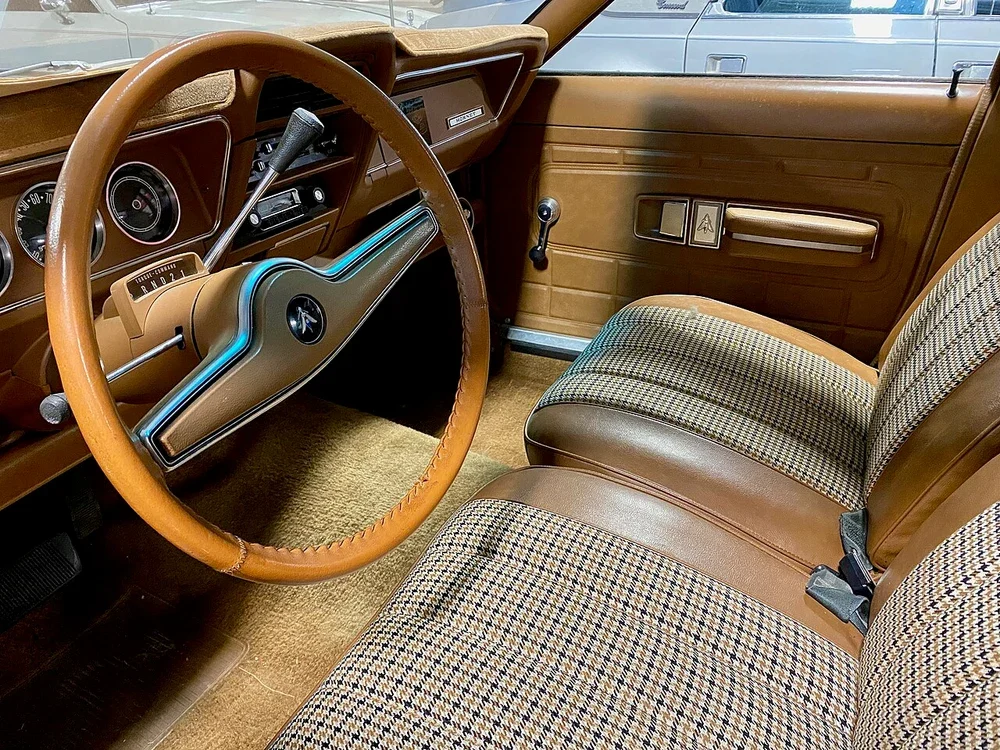 Seats, door trim and steering wheel inside a classic saloon